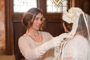 Marion McCallister (Annaliese Gove) adjusts the veil worn by Abby McCallister (Chelsea Flynn) in "The Manor" at Greystone Hall Mansion in West Chester.